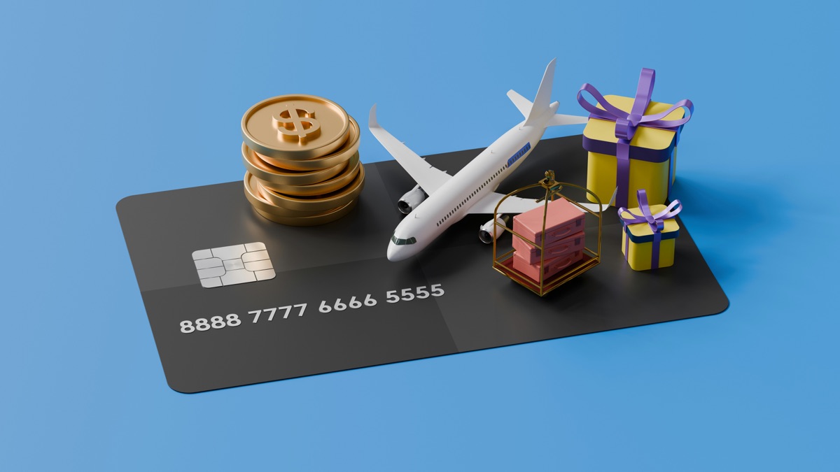 A bank card with a toy airplane, coins and gift boxes on it