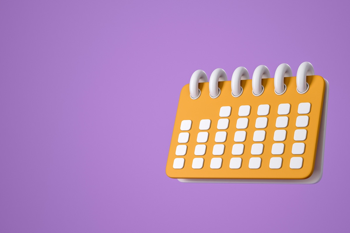 A desk calendar on a purple background