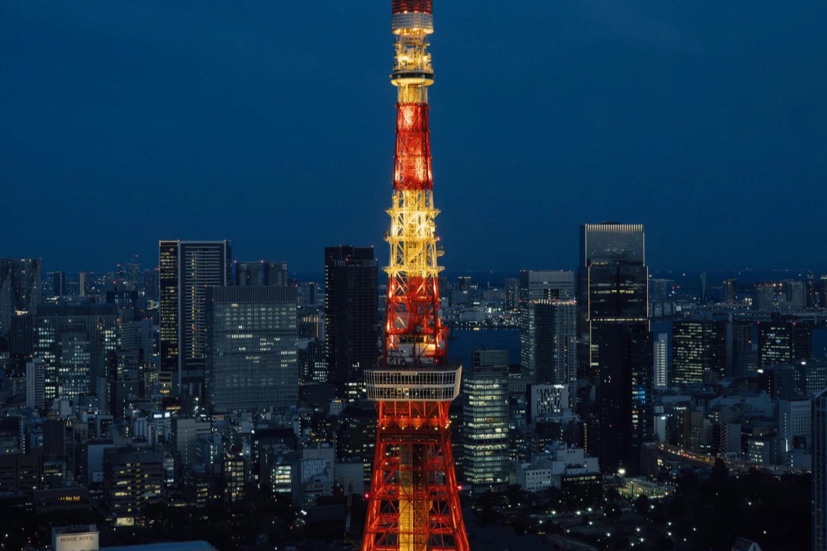 Tokyo Tower lit orange against the city skyline at dusk